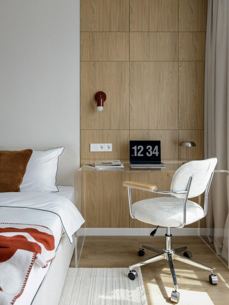 Small bedroom with a bed, compact desk and chair by the wall